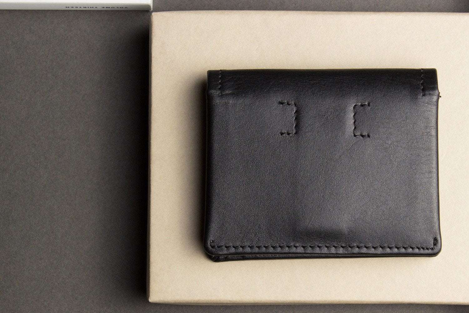 Kiko Slim Bifold Wallet handcrafted leather with 2 card slots and quick-access pocket holding folded cash