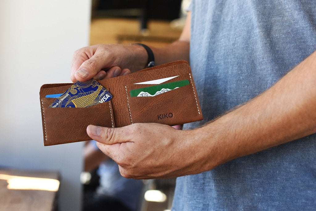 Buck Bifold Leather Wallet made of smooth cowhide with contrast stitching, six card slots, and a full bill compartment.