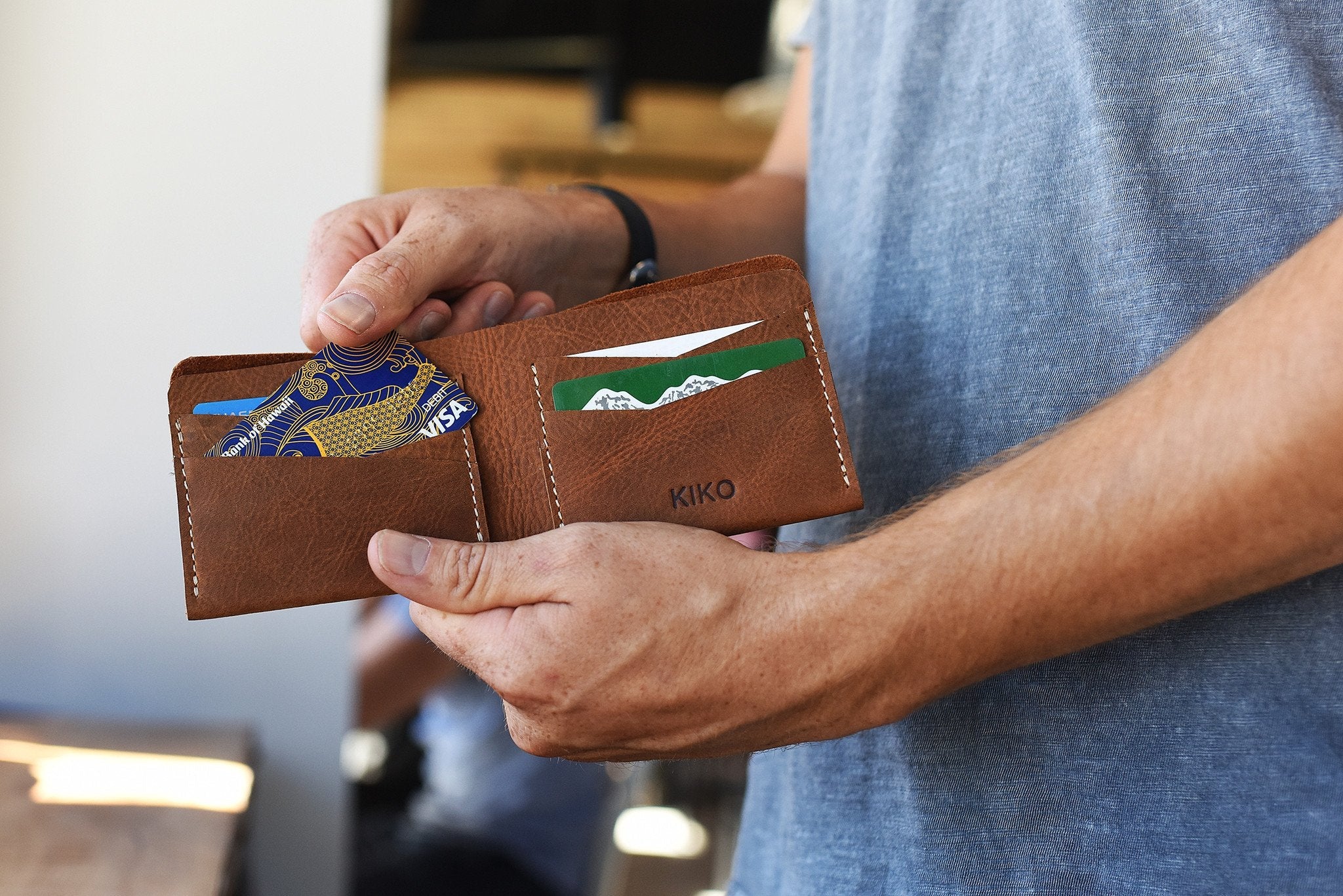 Buck Bifold Leather Wallet made of smooth cowhide with contrast stitching, six card slots, and a full bill compartment.