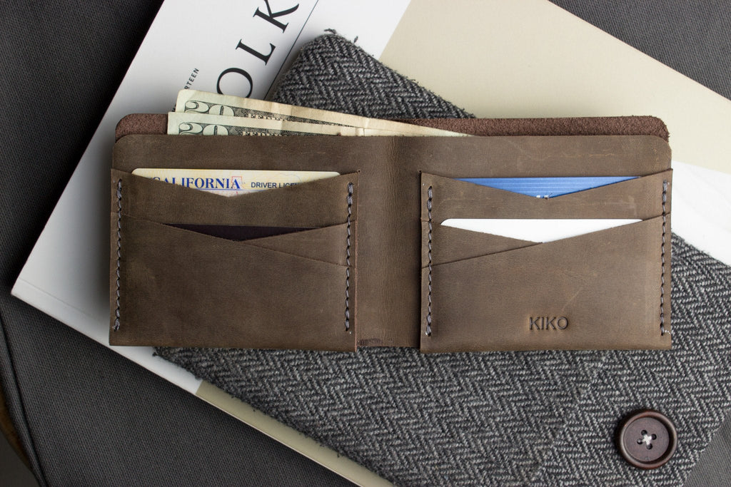 Buck Bifold leather wallet made from smooth cowhide with contrast stitching and six card slots.