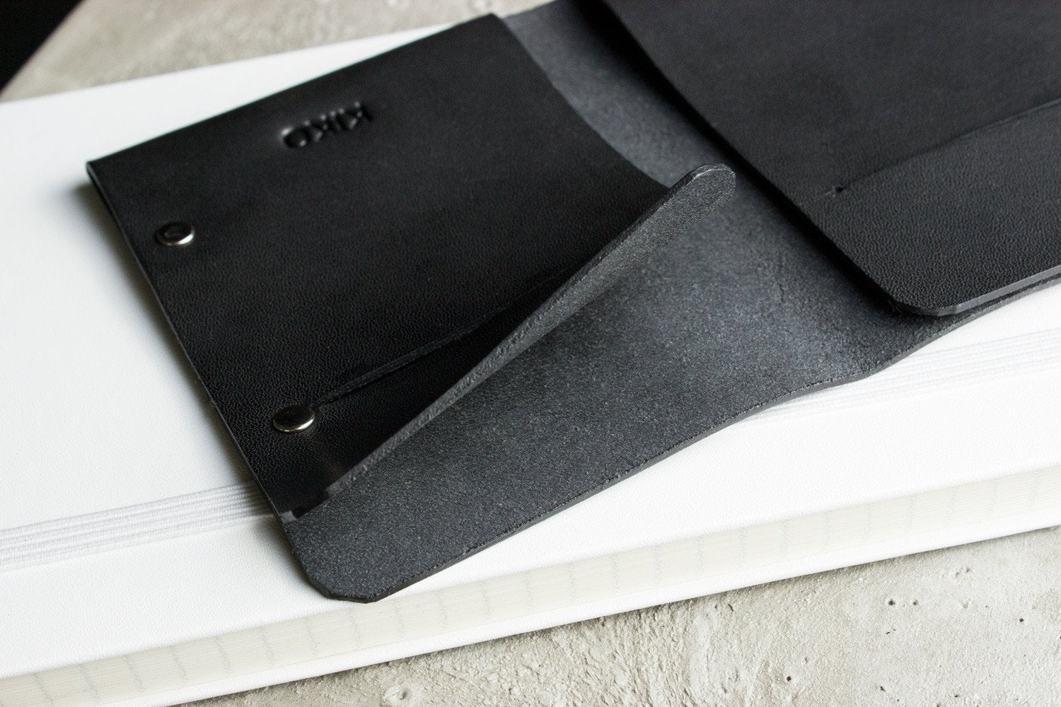 Unstitched leather twofold wallet made from vegetable-tanned cowhide with minimalist design and two card slots