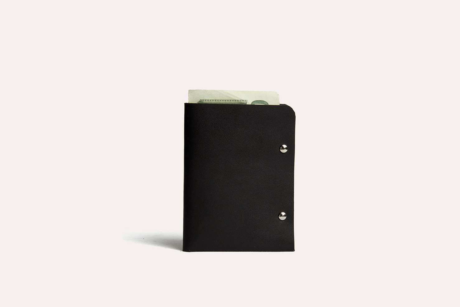 Unstitched leather twofold wallet made from vegetable-tanned cowhide with billfold compartment and two card slots