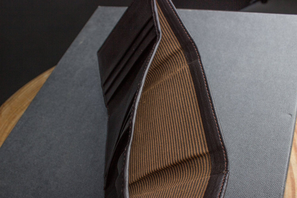 Leather trifold wallet made from butter soft full grain cowhide leather with hand-turned edges and multiple card slots