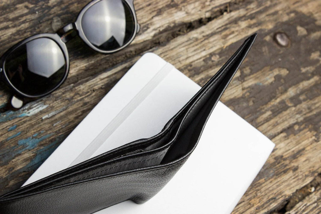 Traditional bifold wallet made of glove tanned cowhide leather with multiple card slots and ID window