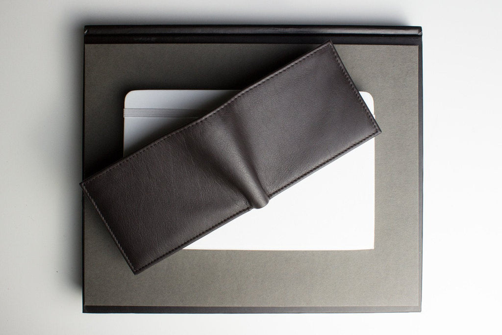 Traditional bifold wallet in glove tanned cowhide leather with removable ID window and multiple card slots