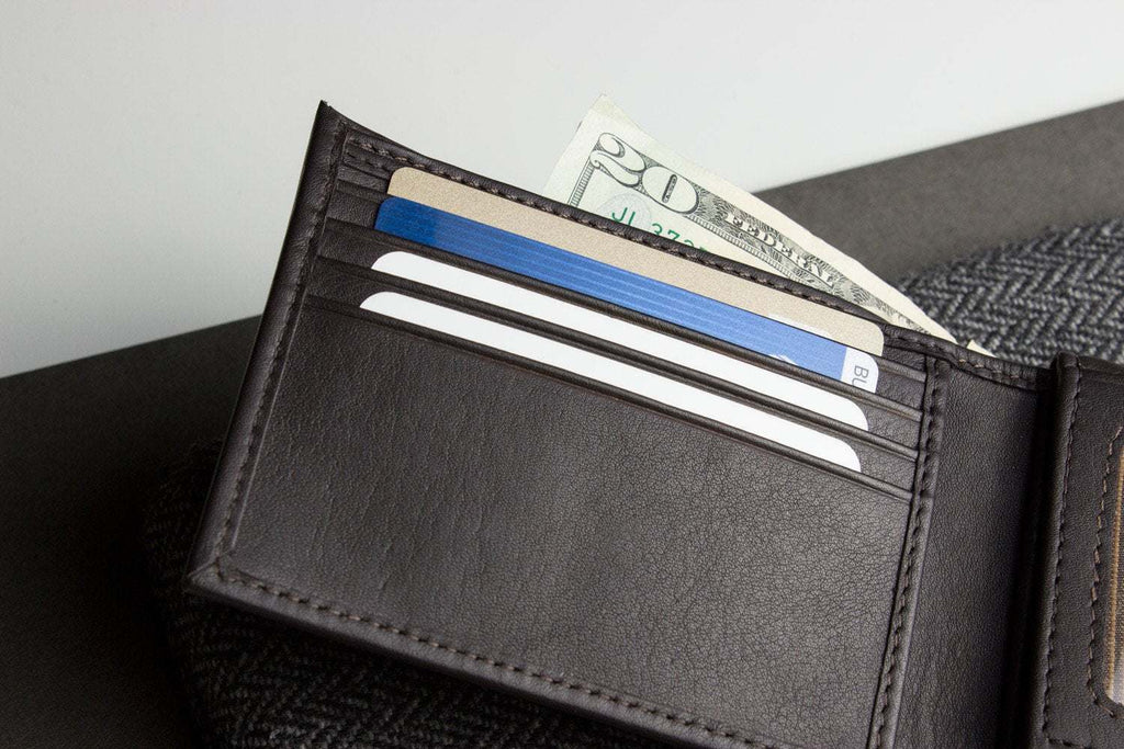 Traditional bifold wallet made of glove tanned cowhide leather with multiple card slots and removable ID window
