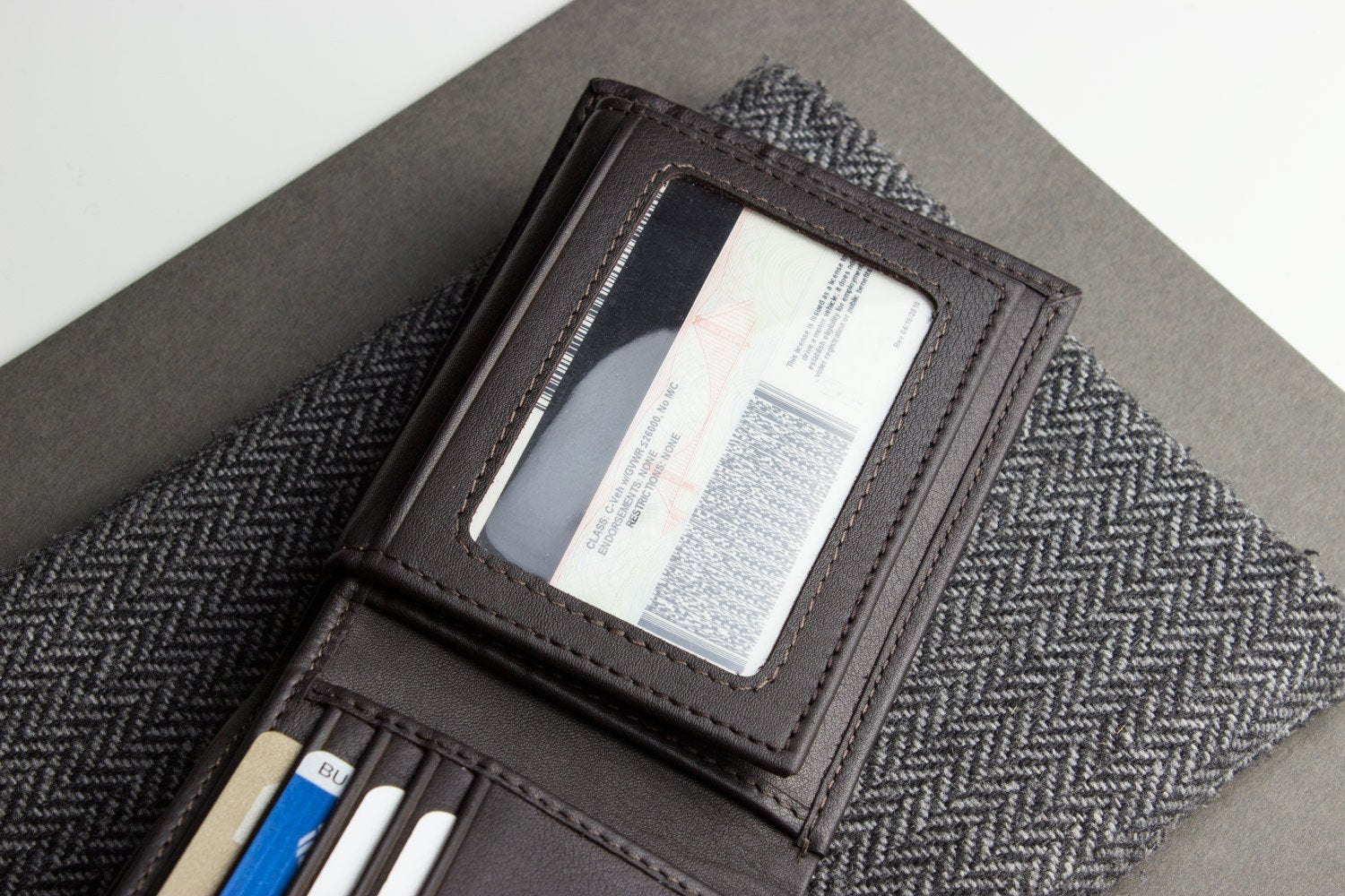 Traditional bifold wallet in glove tanned cowhide leather with removable ID window, 8 card slots, and 2 bill compartments.
