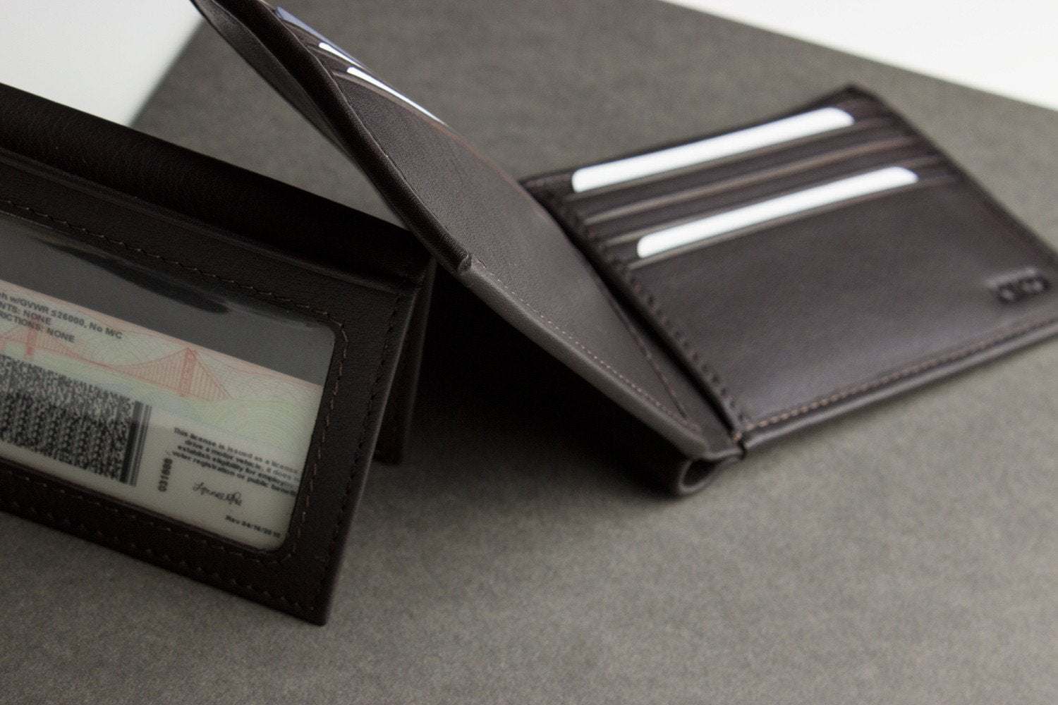 Traditional bifold wallet in glove tanned cowhide leather with multiple card slots and removable ID window