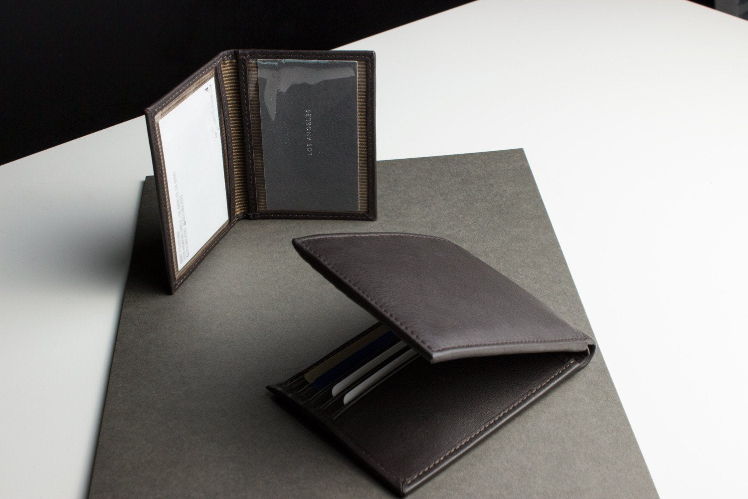 Traditional bifold wallet made of glove tanned cowhide leather with removable ID window and multiple card slots.