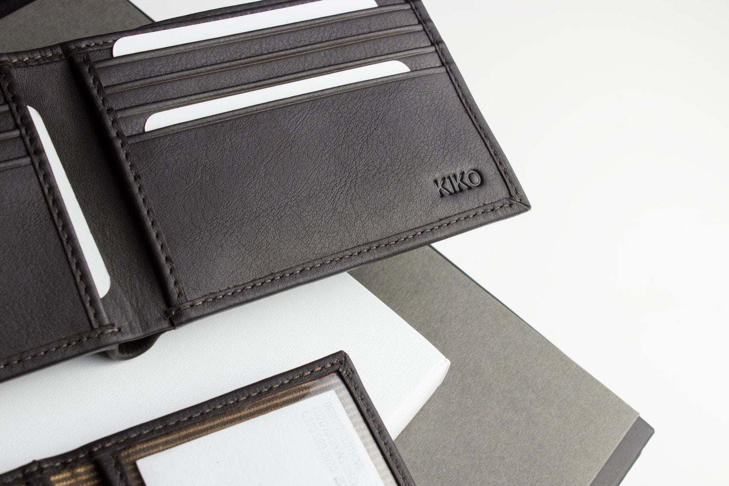 Traditional bifold wallet made of glove tanned cowhide leather with ID window and card slots