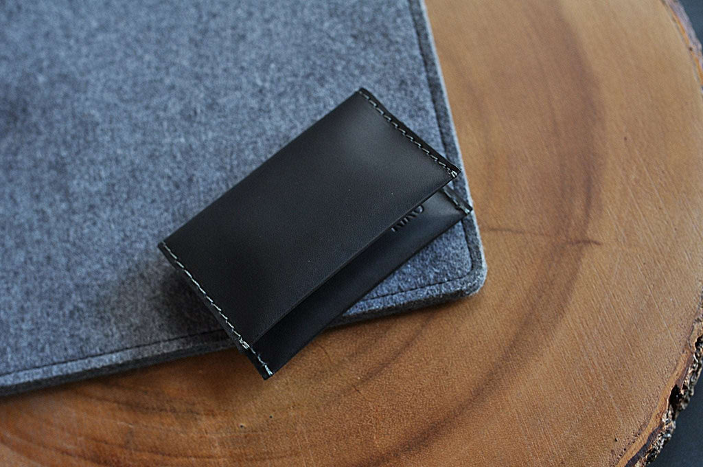 Two Fold Card Wallet in black leather with grey stitching and two card slots