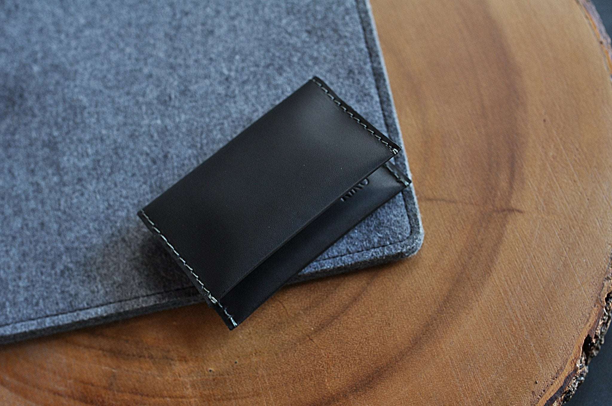 Two Fold Card Wallet in black leather with grey stitching and two card slots