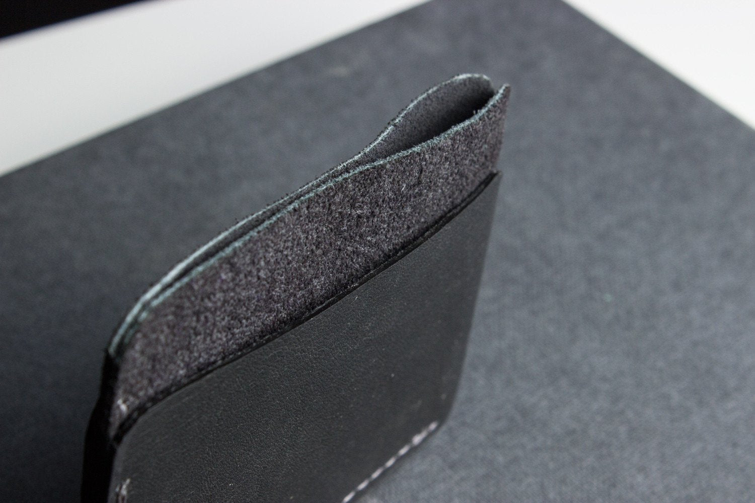 Minimalist handcrafted triple pocket card wallet in top grain cowhide leather with contrast stitching and slim design