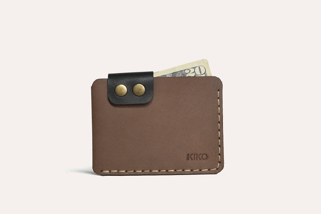 Slim Kiko Card Wallet in smooth leather with brass button flap and rustic stitching for stylish card organization