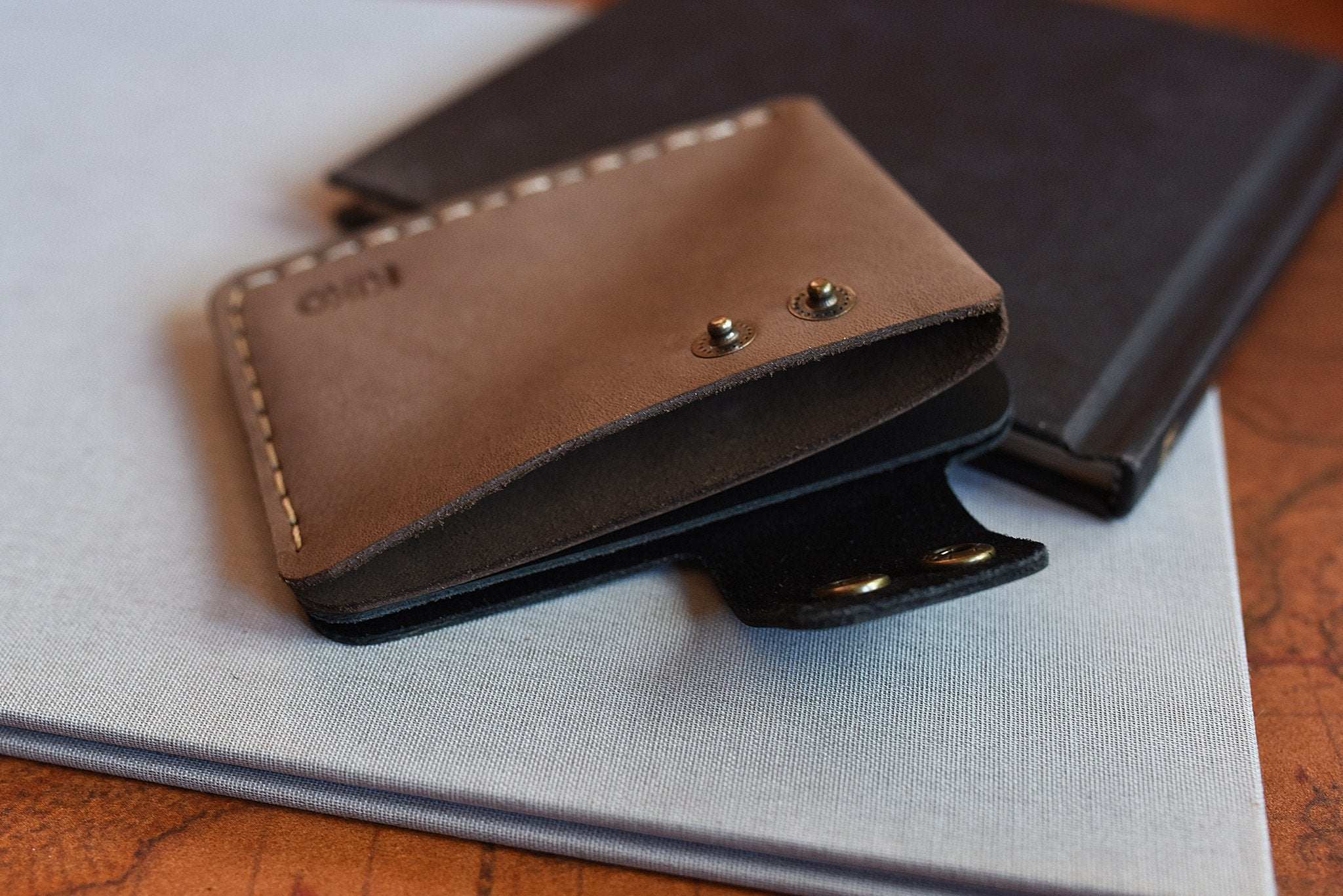 Slim Kiko Card Wallet in smooth leather with brass buttons and secure flap closure for organized card storage