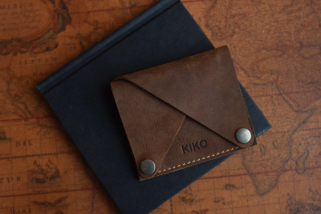 Kiko Wing Fold Wallet in soft leather with geometric design and white stitching, featuring 3 card slots and cash pocket