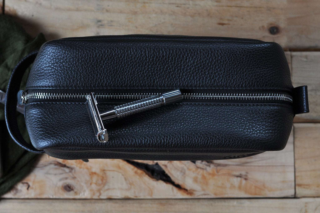 Premium black pebble leather travel kit with spacious interior, YKK zipper, and carrying handle for organized grooming essentials
