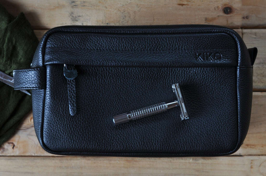 Premium black pebble leather travel kit with YKK zipper and side handle for organized grooming essentials