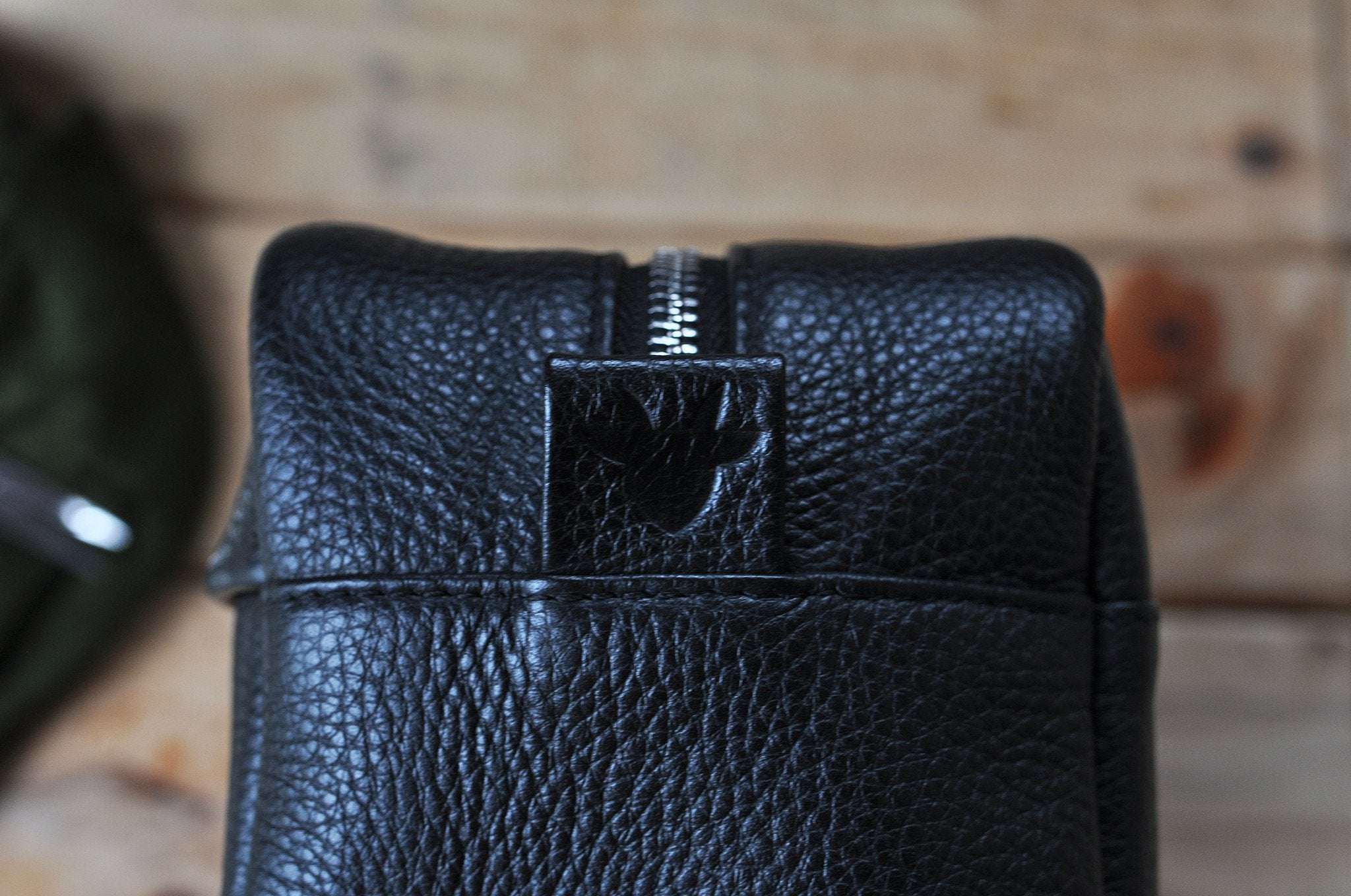 Premium black pebble leather travel kit with spacious interior, YKK zipper, and carrying handle for organized grooming essentials