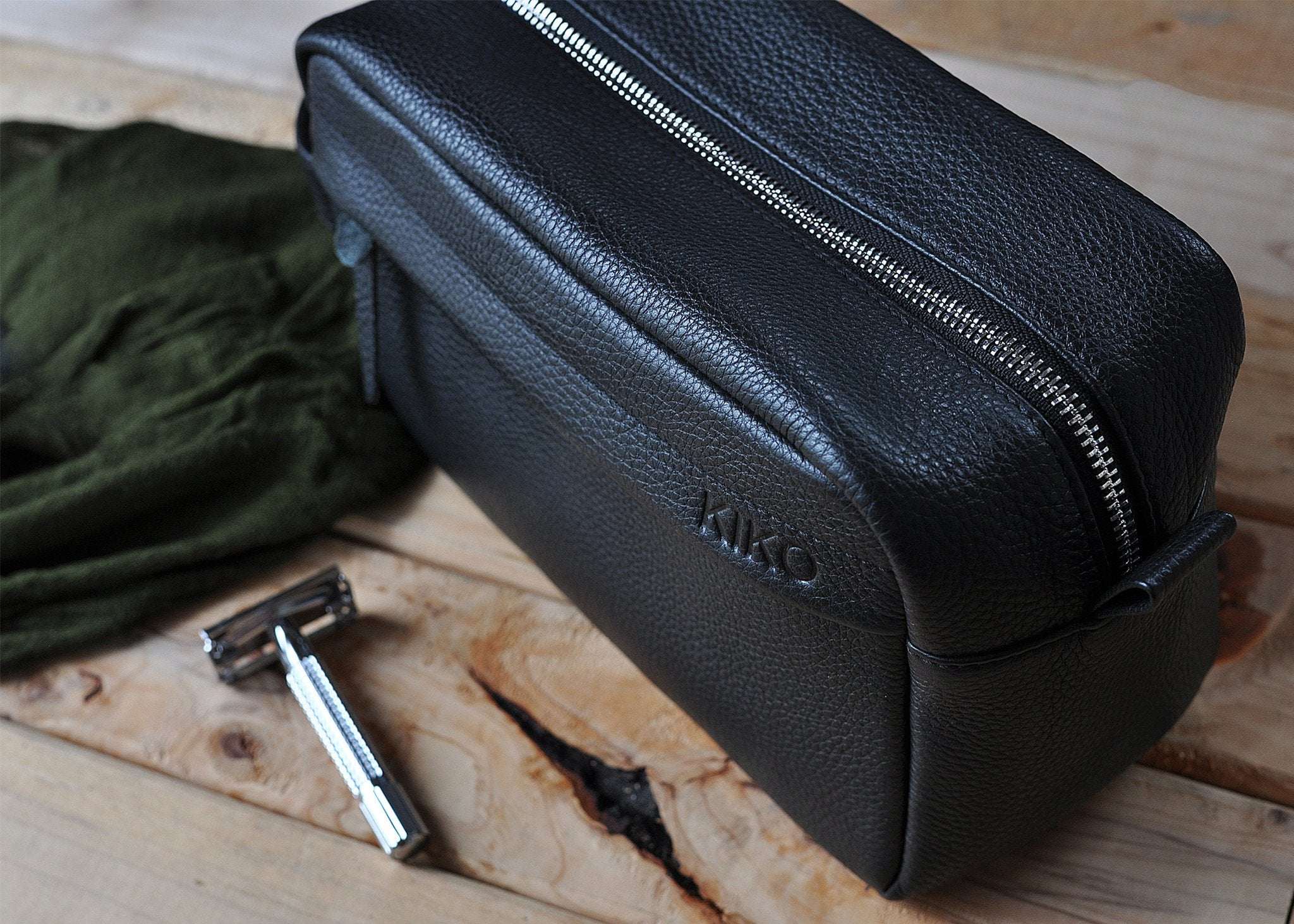 Black premium leather travel kit with YKK zipper and side handle for organized grooming essentials