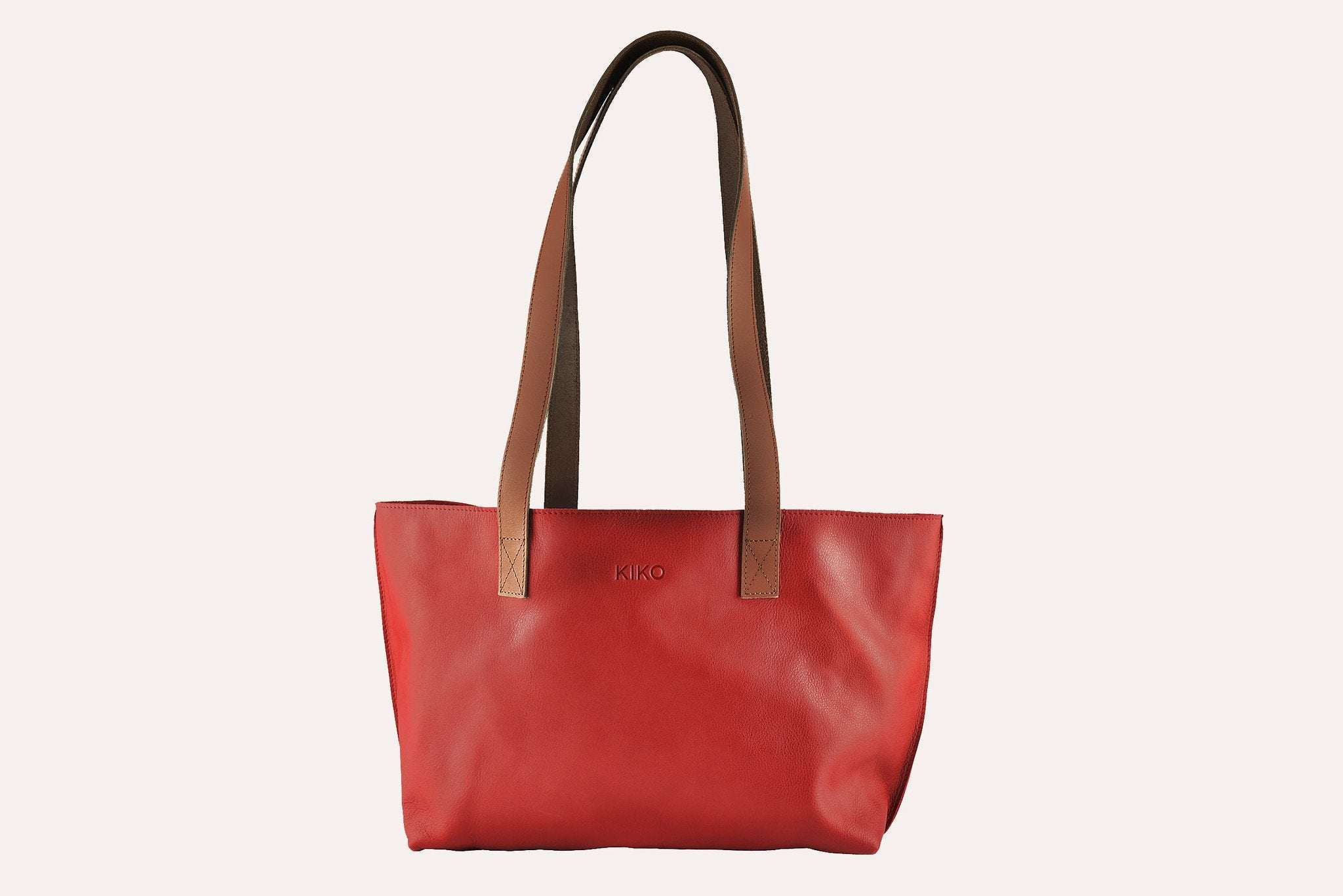 Red leather tote bag with bowl-shaped silhouette and long handles, spacious and unlined interior, perfect for everyday use