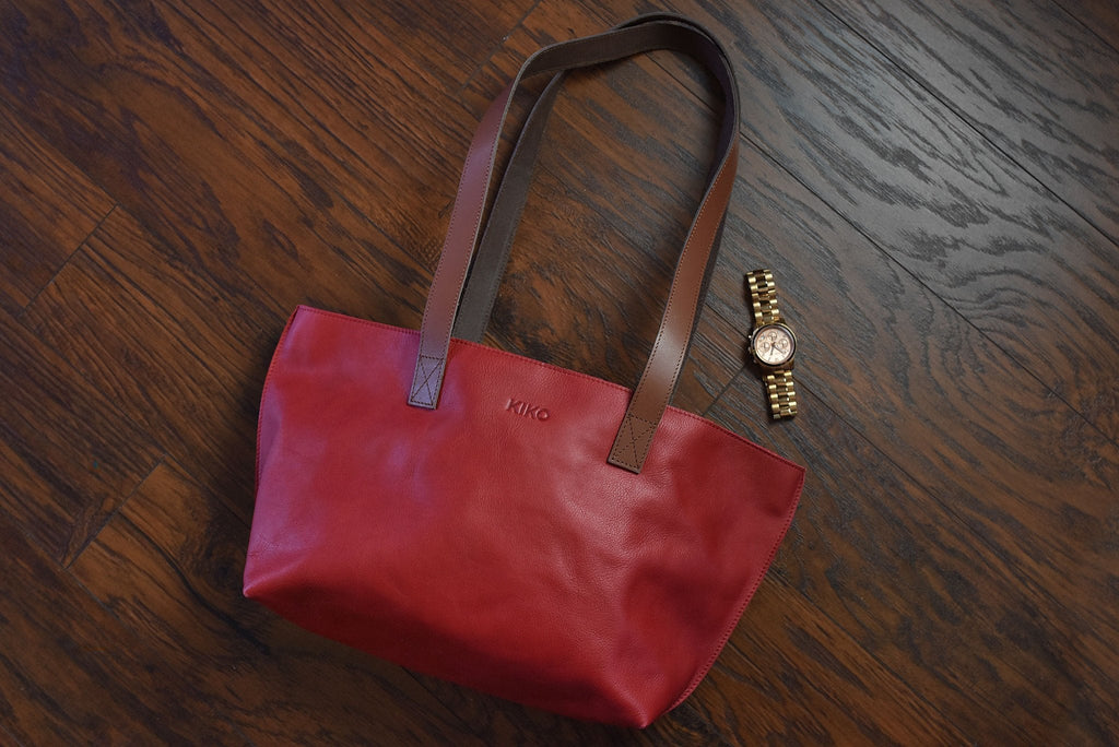 Red tote bag made of genuine leather with bowl-shaped design and shoulder handles
