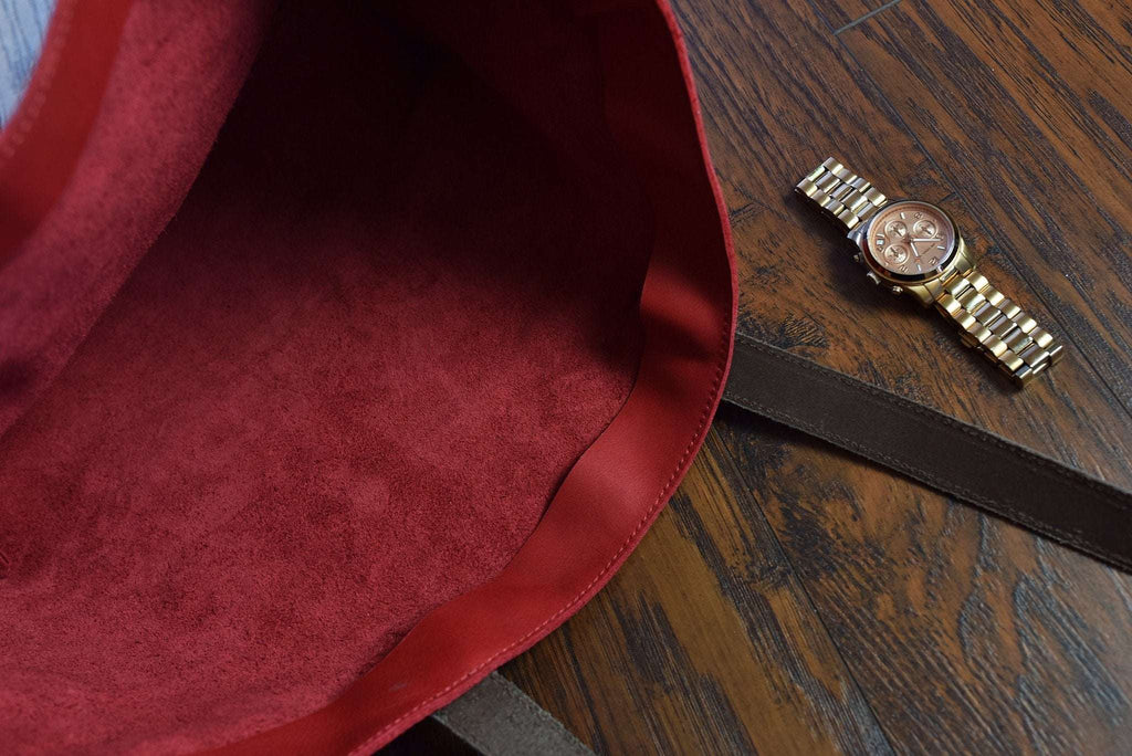 Red leather tote bag with bowl shape and long handles for everyday use