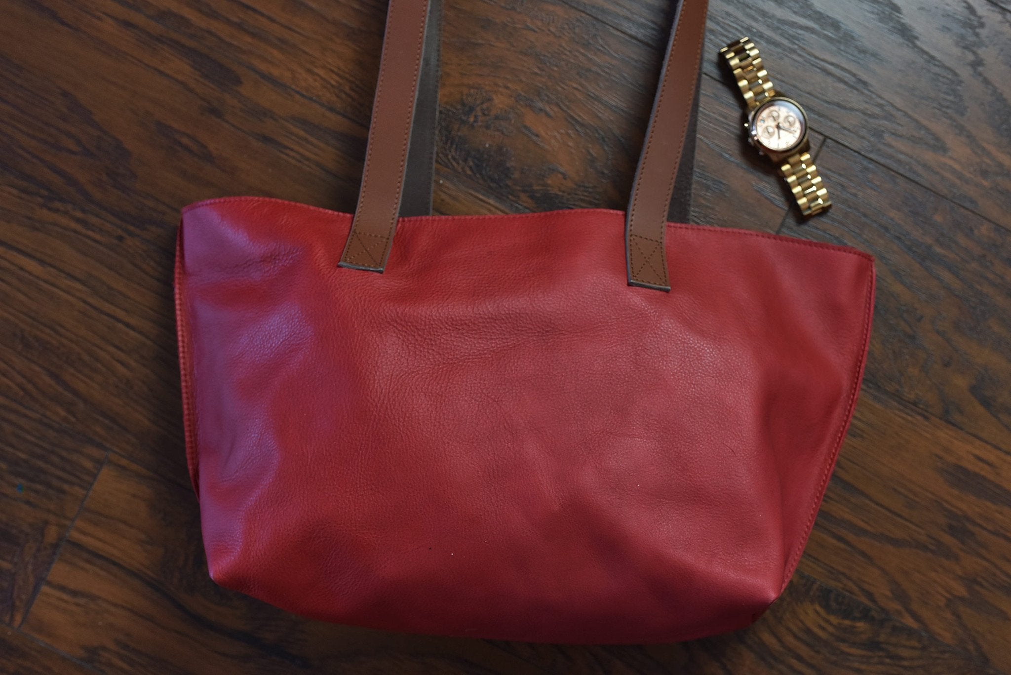 Red genuine leather tote bag with bowl-shaped silhouette and center handles