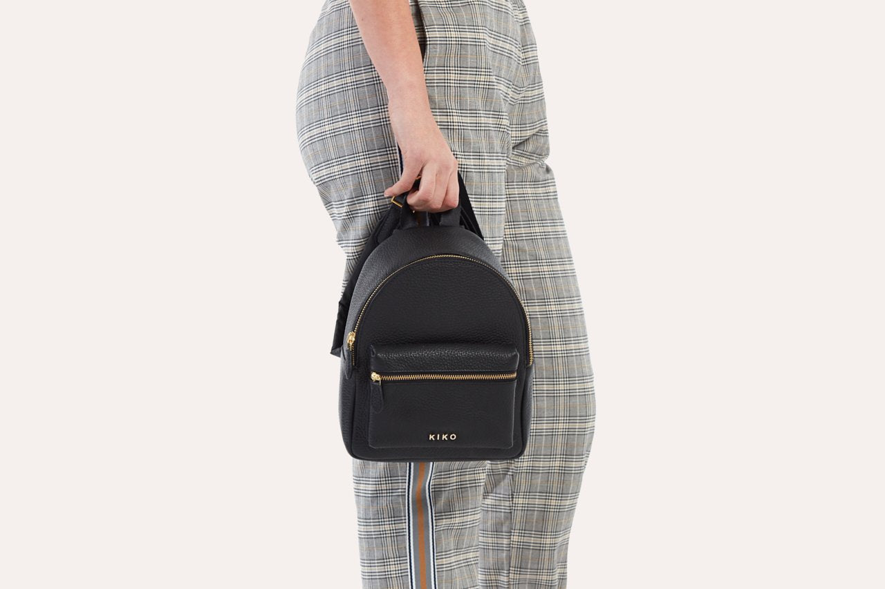 Compact genuine pebble leather backpack with adjustable straps and internal zipper pocket for daily essentials