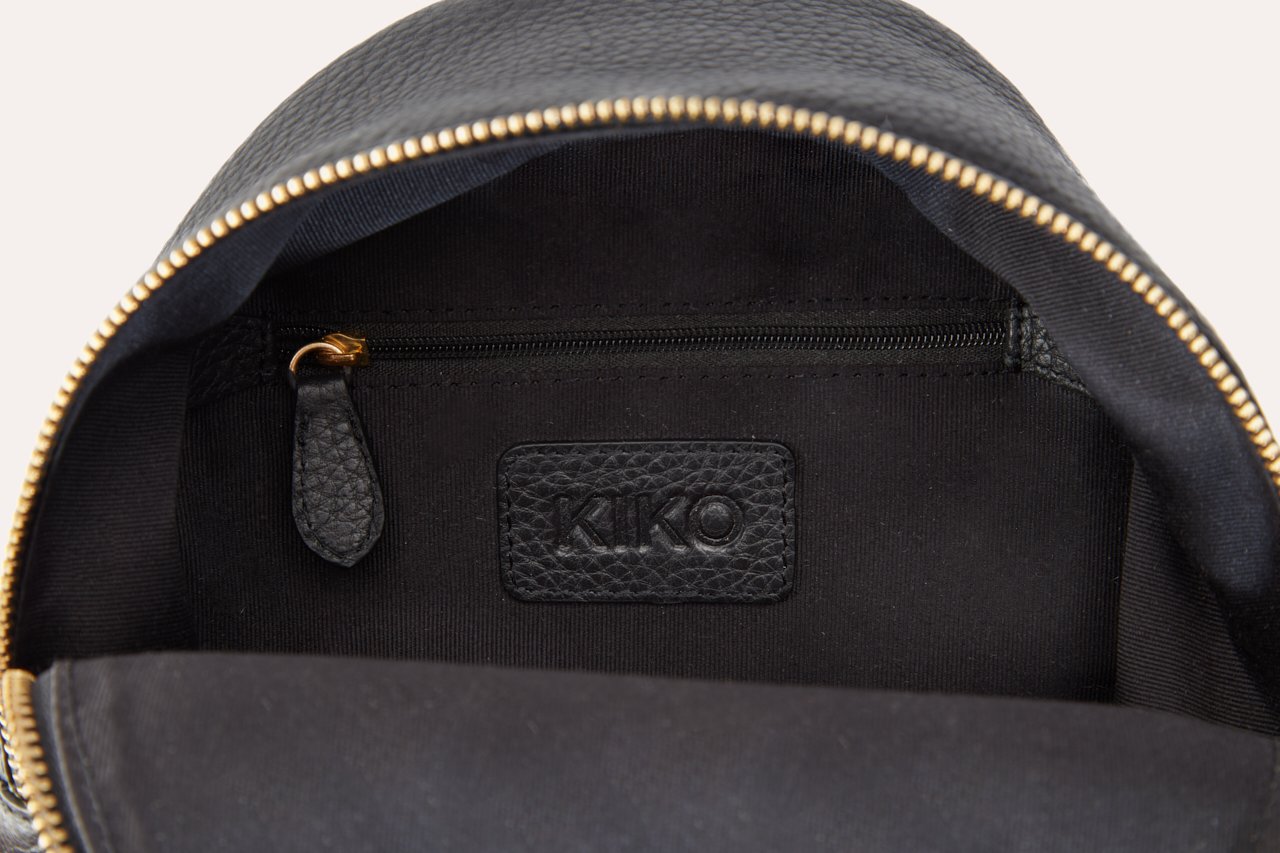 Compact genuine pebble leather backpack with adjustable straps and internal zipper pocket for daily use