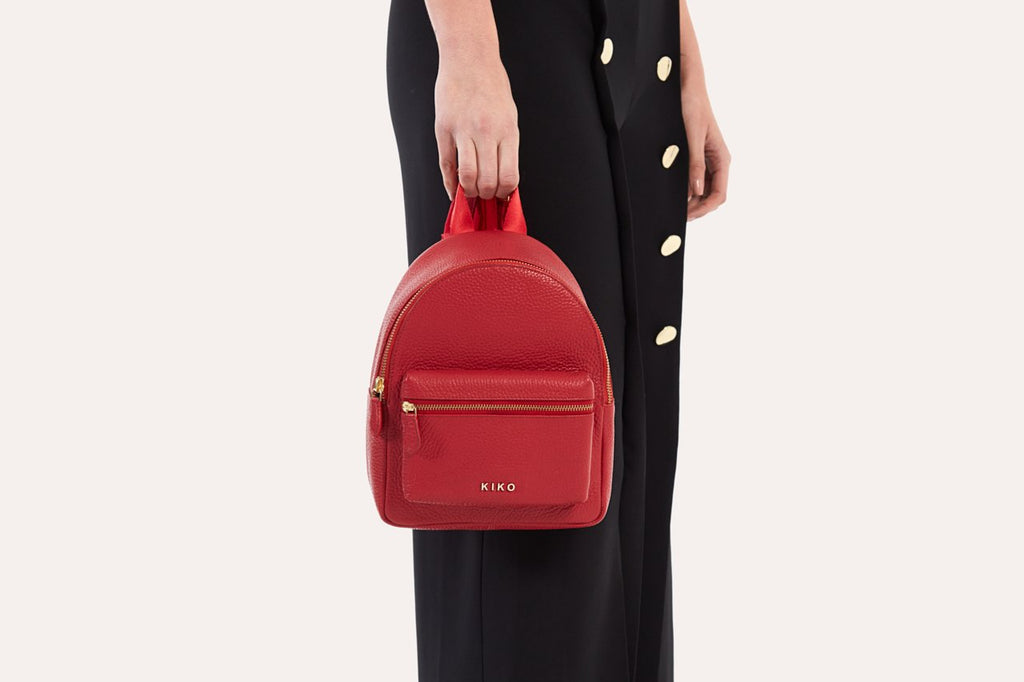Compact genuine pebble leather backpack with adjustable straps and internal zipper pocket for everyday essentials