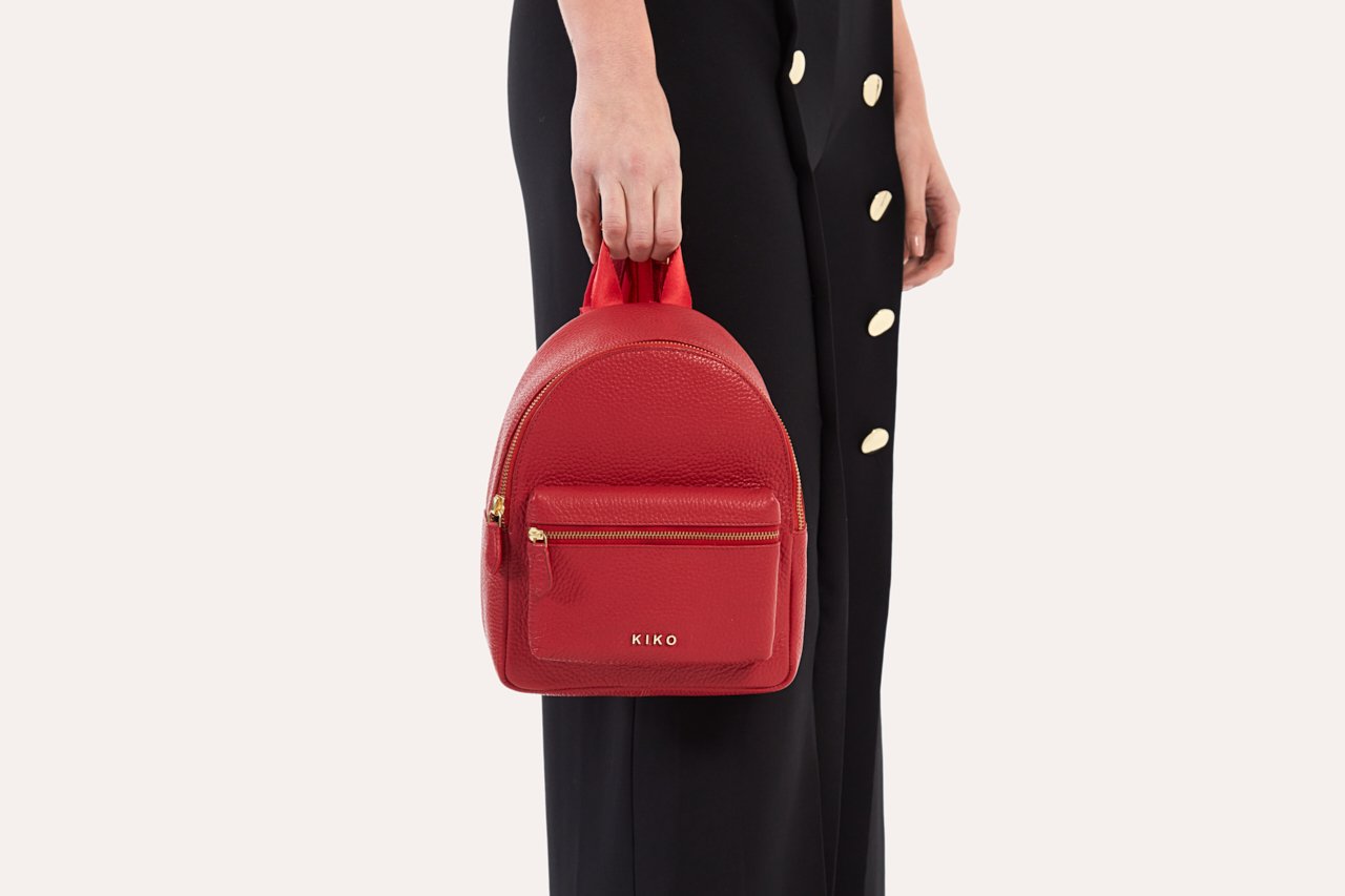 Compact genuine pebble leather backpack with adjustable straps and internal zipper pocket for everyday essentials