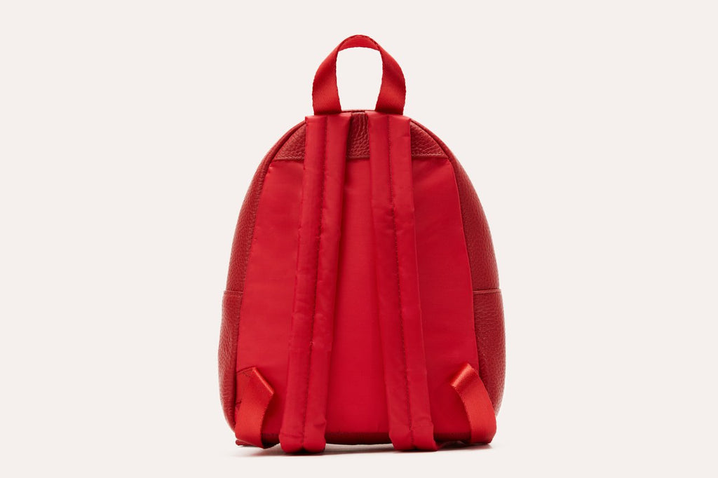 Compact genuine pebble leather backpack with adjustable straps and internal zipper pocket for everyday essentials