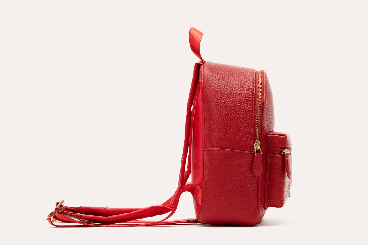 Compact genuine pebble leather backpack with adjustable straps and internal zipper pocket for everyday essentials