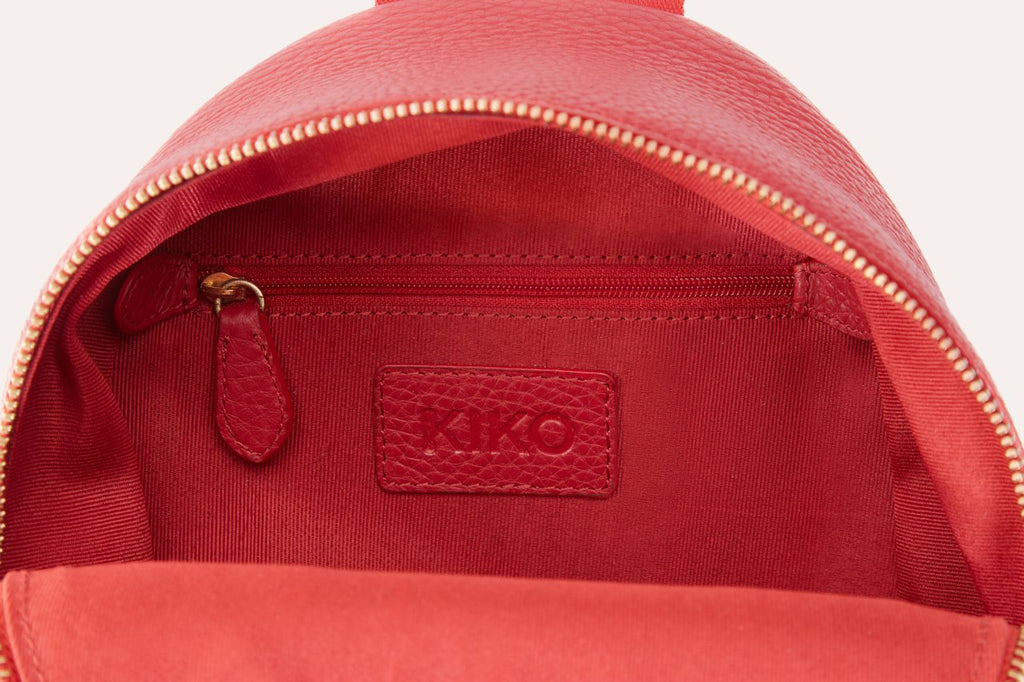 Compact genuine pebble leather backpack with adjustable straps and internal zipper pocket for everyday essentials