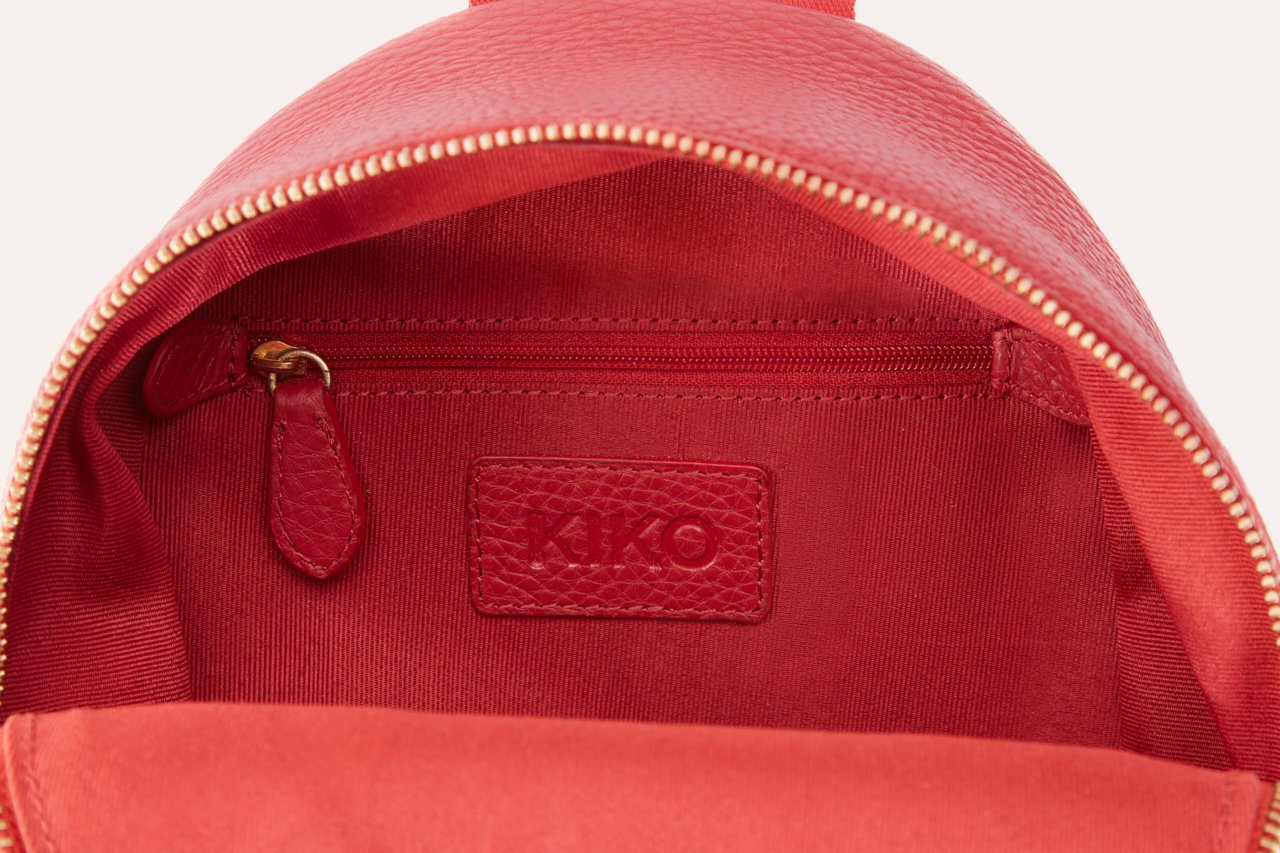 Compact genuine pebble leather backpack with adjustable straps and internal zipper pocket for everyday essentials