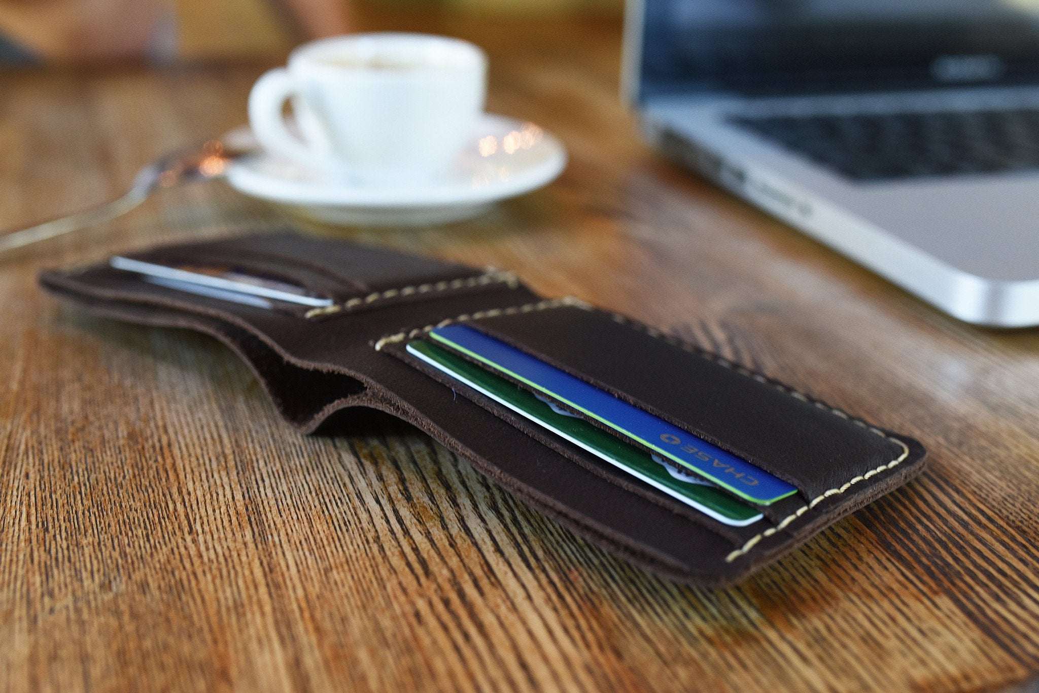 Wave Bifold Leather Wallet with 6 card slots, bill compartment, light stitching, slim design, and compact size