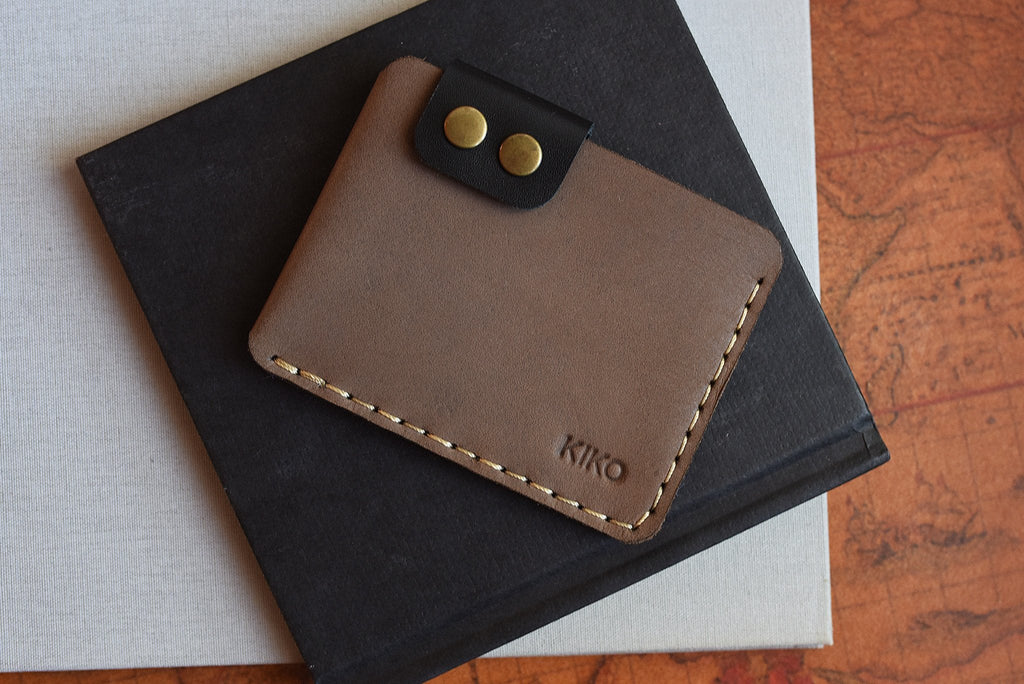 Slim Kiko Card Wallet in leather with brass buttons and secure flap closure