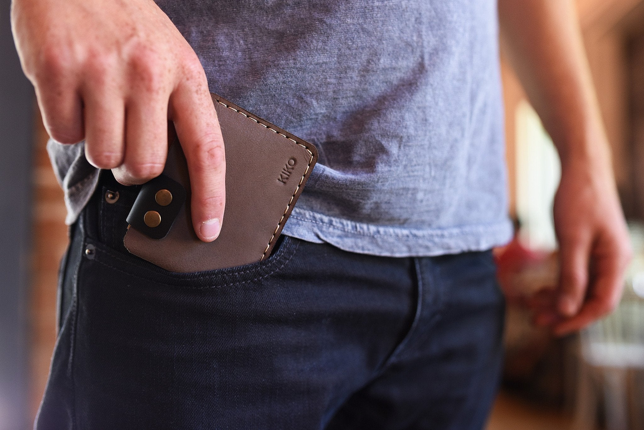 Slim Kiko Card Wallet in smooth leather with button flap and brass accents for stylish card organization
