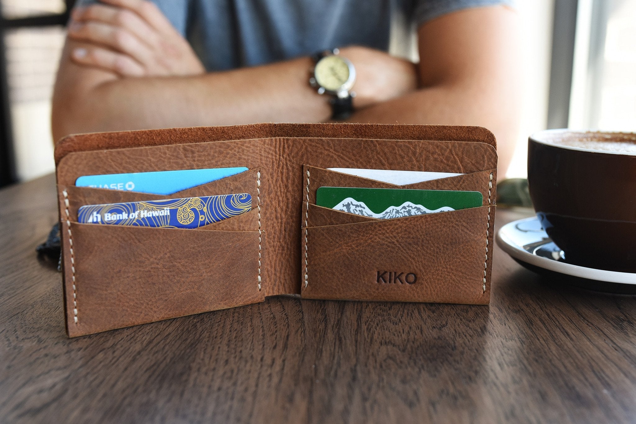 Buck Bifold Leather Wallet in smooth cowhide with contrast stitching, six card slots, and full bill compartment for sleek everyday carry