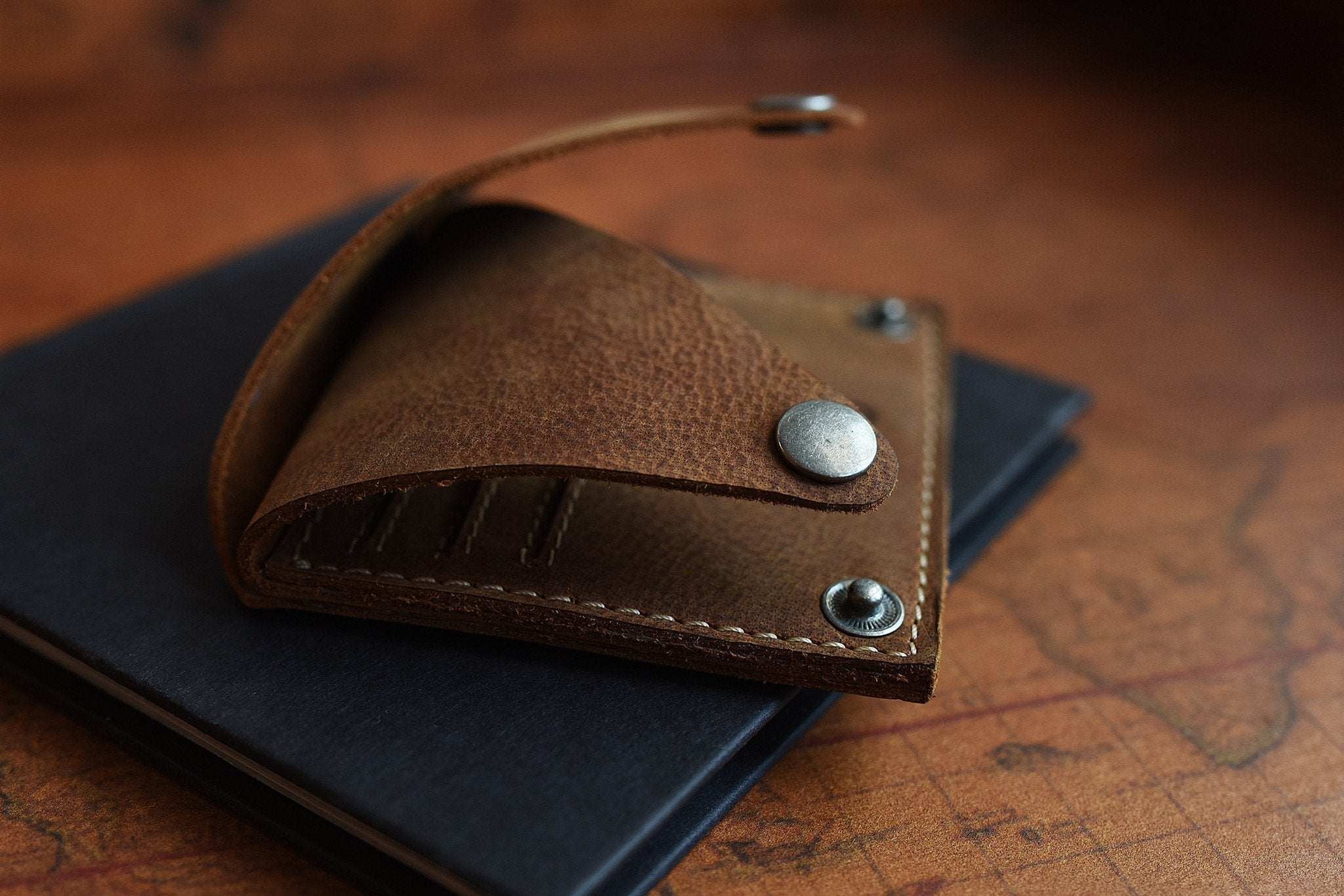 Kiko Wing Fold Wallet with geometric leather design, card slots, and button closures