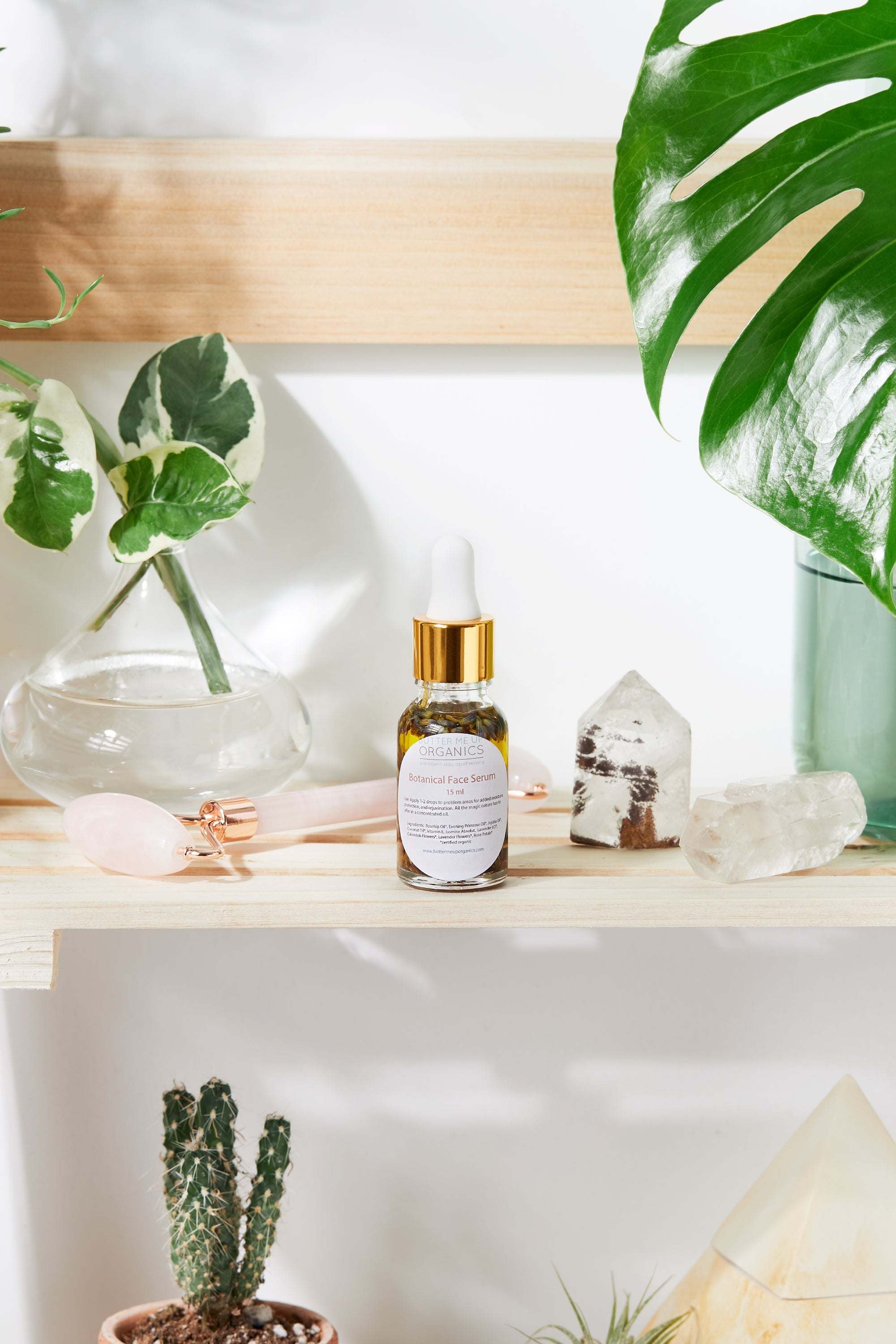 Luxurious healing face serum in elegant Italian glass bottle with yellow oils and herbs by Butter Me Up Organic Anti Aging Youth Facial Serum