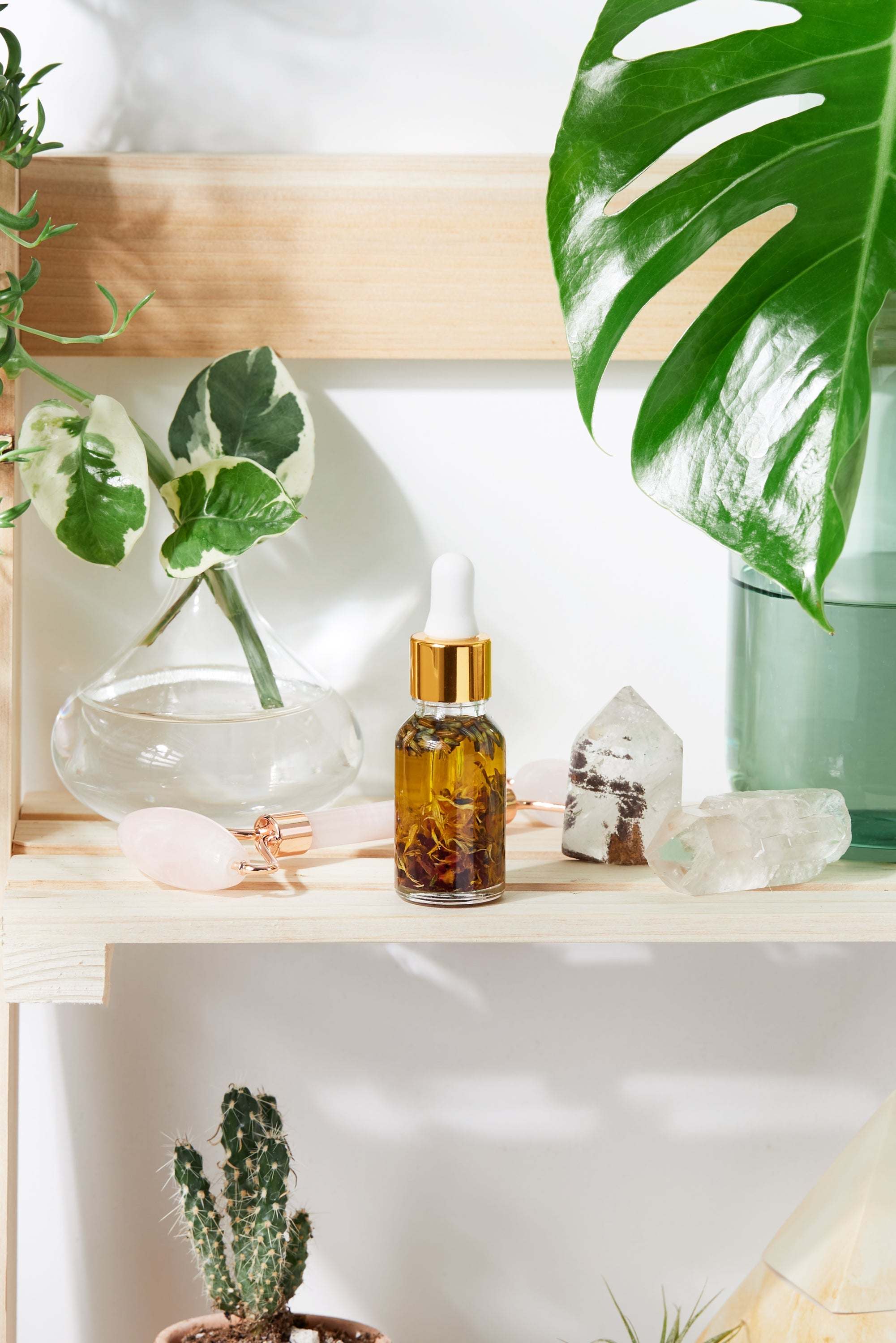 Luxurious healing face serum in elegant Italian glass bottle with yellow oils and herbs by Butter Me Up
