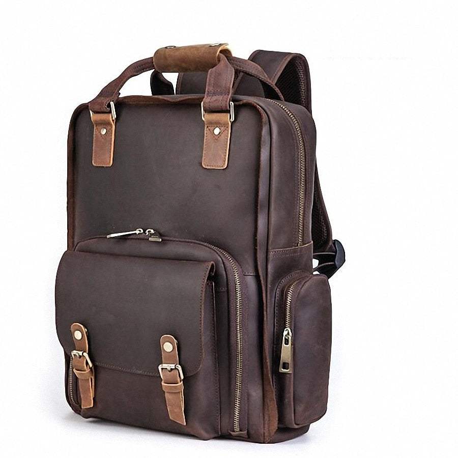 Large leather camera bag backpack made of full-grain crazy horse leather with padded straps and multiple compartments for camera gear and laptop.