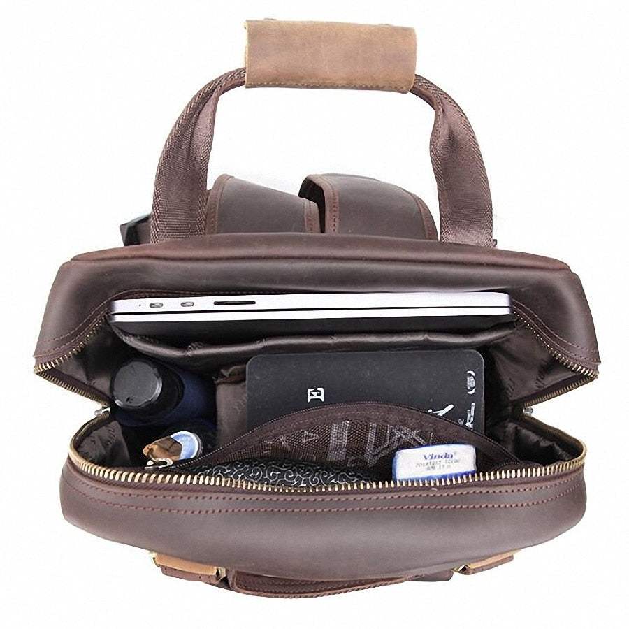 Large leather camera bag backpack made from full-grain crazy horse leather with padded straps and multiple compartments for camera gear and laptop.