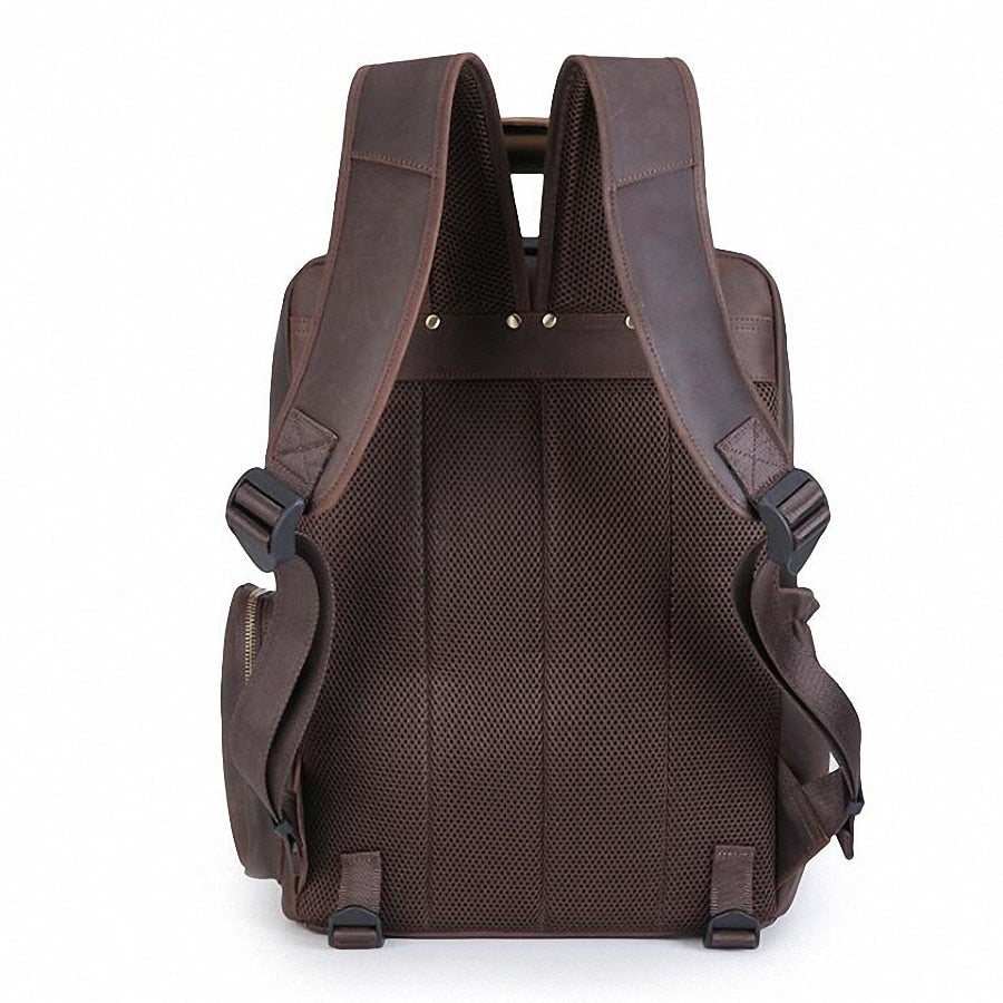 Large leather camera bag backpack made from full-grain crazy horse leather with padded straps and multiple compartments for camera gear and laptop.