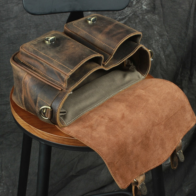 The Faust Leather Crossbody Messenger Bag in full-grain crazy horse leather with adjustable strap and spacious camera compartments