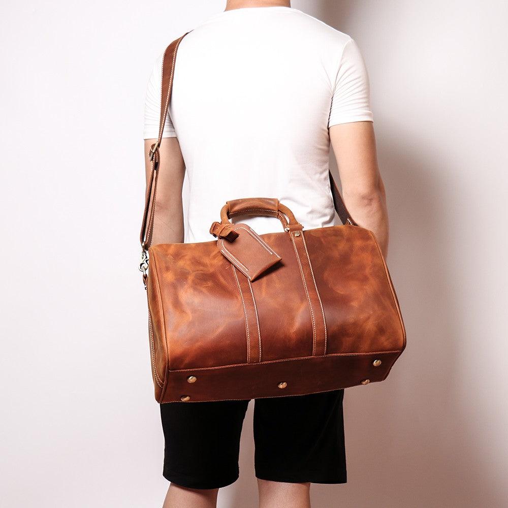 The Brandt Weekender small black leather duffle bag with leather handle and adjustable shoulder strap