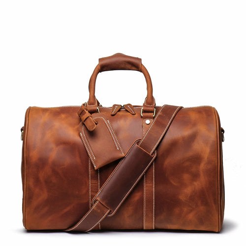 The Brandt Weekender small black leather duffle bag with adjustable shoulder strap and top handle
