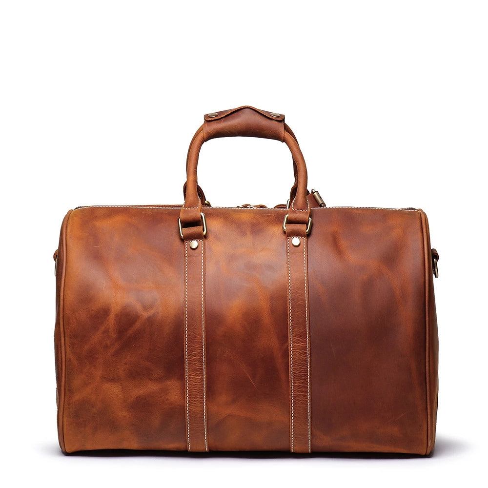 The Brandt Weekender small black leather duffle bag with shoulder strap and handles
